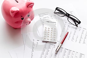 Taxes calculation concept. Financial documents, piggy bank, calculator on white background