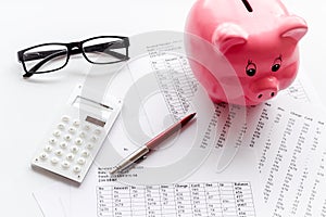 Taxes calculation concept. Financial documents, piggy bank, calculator on white background