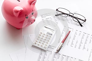 Taxes calculation concept. Financial documents, piggy bank, calculator on white background