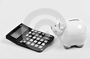 Taxes and fees concept. Tax savings. Piggy bank money savings. Investing gain profit. Piggy bank pig and calculator