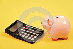 Taxes and fees concept. Tax savings. Piggy bank money savings. Investing gain profit. Piggy bank pig and calculator