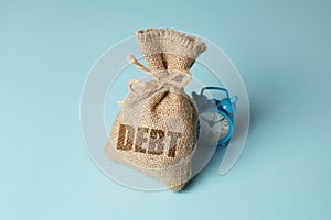 Taxes and interest on debt payments. Overdue payments, penalties. Bag with money and clock on blue background