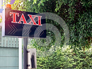 Taxi calling sign with red flashing emergency light for residents in village