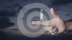 Taxi car icon on finger over sunset sky, Business transportation service concept