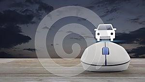 Taxi car icon with wireless computer mouse on wooden table over sunset sky, Business transportation service online concept