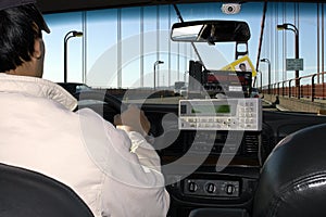 A taxi driver driving across the Golden Gate bridge,San Francisco,usa