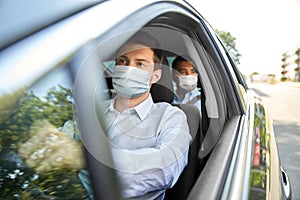 Taxi driver in face protective mask driving car