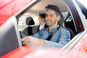 Taxi driver with passenger at back seat.