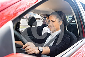 Taxi driver with passenger at back seat.