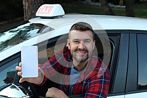 Taxi driver showing app in smartphone