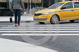 A taxi at a pedestrian crossing misses a person