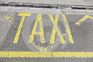 Taxi sign on asphalt