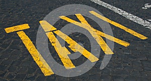 Taxi sign on cobblestones