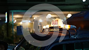 Taxi sign illuminate at night wait for passenger disrupted transportation indutry photo