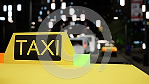 Taxi sign on yellow car