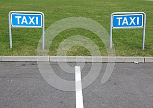 Taxi Signs at Empty Parking Place with Green Background