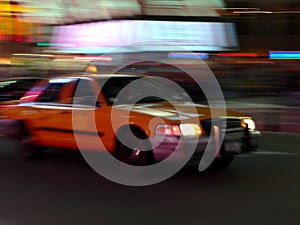 Taxi speeds down the street
