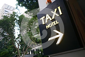 taxi stand sign on black in singapore