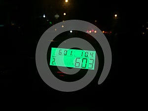 A taximeter that tells the rate and total costs of the ride seen from inside the taxi