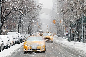 Taxis drive down a snow covered 5th Avenue during a winter storm in New York City