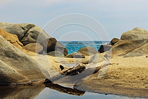 Tayrona National Park surrounded by turquoise sea and white sand beach in Colombia