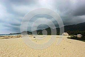 Tayrona National Park surrounded by turquoise sea and white sand beach in Colombia