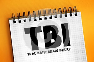 TBI Traumatic Brain Injury - intracranial injury to the brain caused by an external force, acronym text concept on notepad