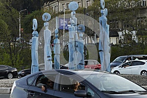 Tbilisi, Georgia - 18 April, 2024: The nine-figure Statue of Clocks near Galaktion Tabidze Bridge