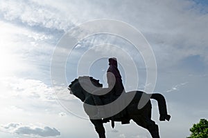 Tbilisi, Georgia, JULY, 2019: Stone equestrian statue rider with sword and raised hand on the river Bank