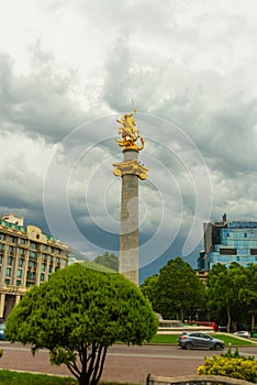 TBILISI, GEORGIA: Liberty Monument Depicting St George Slaying The Dragon And Tbilisi City Hall In Freedom Square
