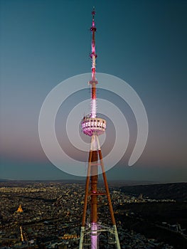 Tbilisi TV Tower in Mtatsminda Park against a cityscape photo