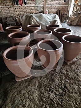 TClay pots that have just been made by craftsmen wait to dry and are then fired in a furnace