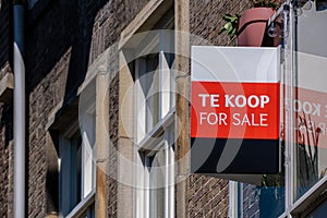 Te Koop For Sale in Dutch on the facade of a building