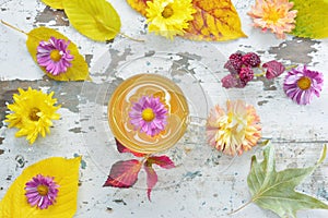 Tea and autumnal cherry leaf and chrysanthemums