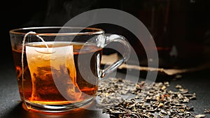 Tea bag in a hot tea cup on a table