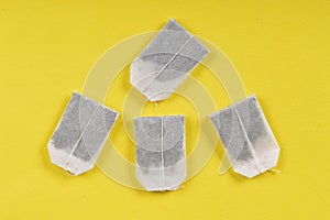 Tea bag sachets isolated on a yellow background