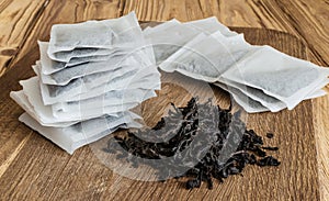Tea bags and loose tea on a wooden board