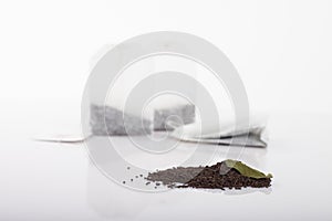 Tea bags over dried leafs leaves background