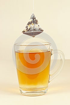 Tea bags over glass with freshly brewed tea