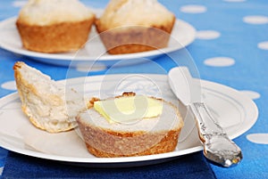 Tea biscuit with butter on a plate