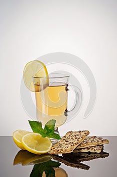 Tea with biscuits, lemon and mint