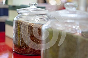 Tea blends in glass jars on the counter of the cafe. Bright colors of tea