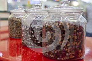 Tea blends in glass jars on the counter of the cafe. Bright colors of tea