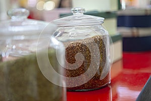 Tea blends in glass jars on the counter of the cafe. Bright colors of tea