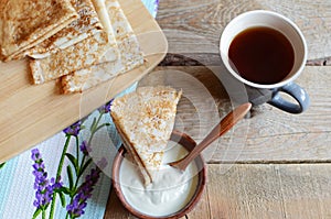 Tea break with Russian style pancakes during Maslenitsa Old wooden background