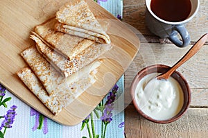 Tea break with Russian style pancakes during Maslenitsa Old wooden background