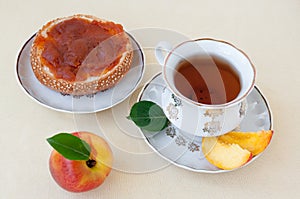 Tea with a bun with jam and nectarine