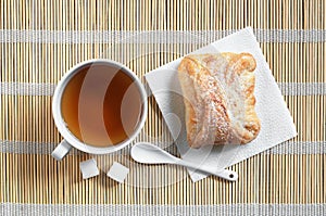 Tea and bun of puff pastry