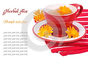 Tea with calendula on a red napkin isolated