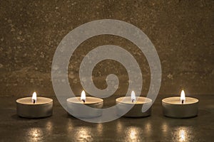 Tea candles on concrete